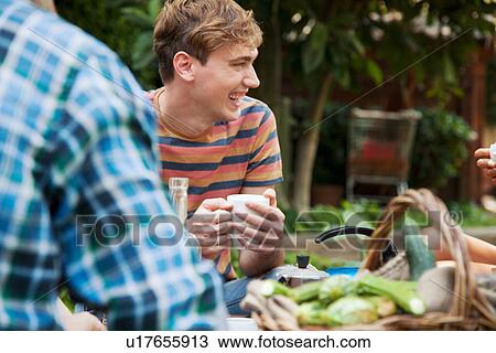 Friends sitting in garden with basket of fresh vegetables View Large Photo Image Stock Image - Friends sitting in garden with basket of fresh vegetables. Fotosearch