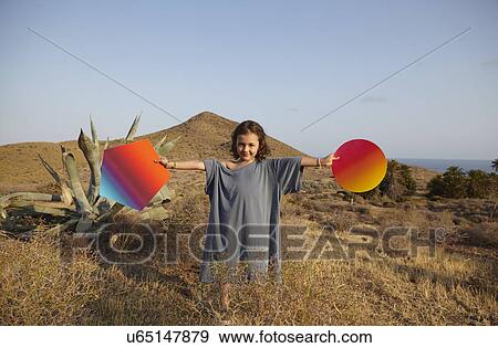 Girl holding bright shapes in desert, Cabo de Gata, Almeria, Spain View Large Photo Image Stock Photo - Girl holding bright shapes in desert, Cabo de Gata, Almeria, Spain. Fotosearch