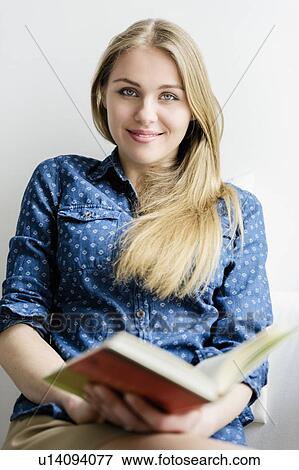 Girl looking up from book View Large Photo Image Stock Photo - Girl looking up from book. Fotosearch