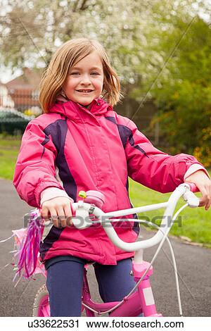 Stock Image - Girl on bicycle. Fotosearch