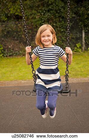 Stock Photograph - Girl on swing. Fotosearch