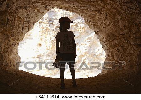 Girl standing in entrance of cave, Cabo de Gata, Almeria, Spain View Large Photo Image Picture - Girl standing in entrance of cave, Cabo de Gata, Almeria, Spain. Fotosearch