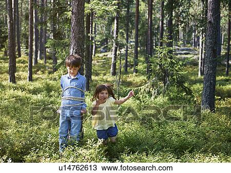 Girl tying brother to tree View Large Photo Image Stock Image - Girl tying brother to tree. Fotosearch