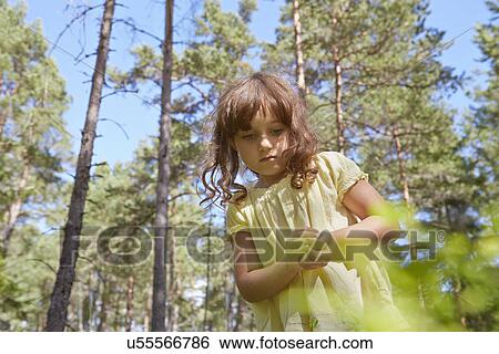 Girl with hands clasped in forest View Large Photo Image Stock Photograph - Girl with hands clasped in forest. Fotosearch