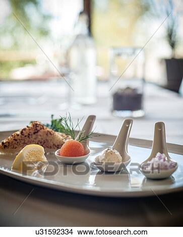 Picture - Gourmet dish with individual servings on spoons. Fotosearch