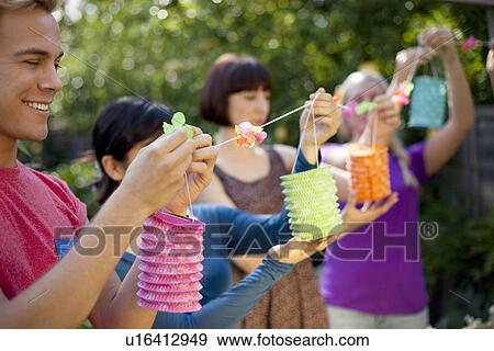 Group of friends hanging chinese lanterns View Large Photo Image Stock Photo - Group of friends hanging chinese lanterns. Fotosearch