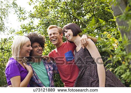 Group of young adult friends in garden View Large Photo Image Stock Photo - Group of young adult friends in garden. Fotosearch
