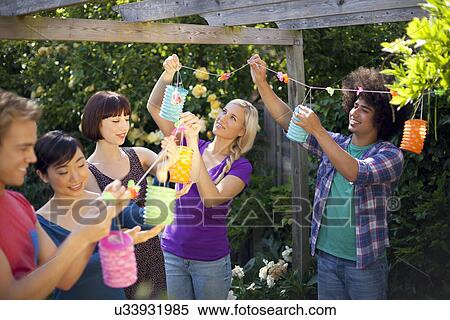 Group of young friends holding up chinese lantern View Large Photo Image Stock Photography - Group of young friends holding up chinese lantern. Fotosearch
