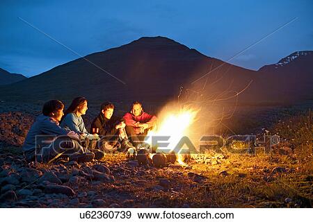 Stock Photo - Group sitting at campfire, Eyjafjordur, North Iceland. Fotosearch