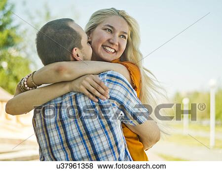 Happy young couple embracing View Large Photo Image Stock Photo - Happy young couple embracing. Fotosearch