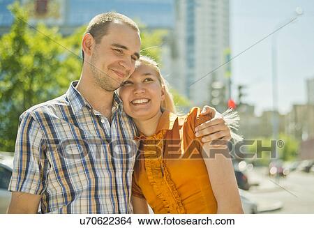 Picture - Happy young couple hugging. Fotosearch