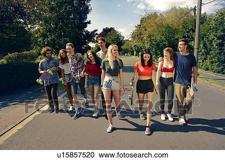 Large group of young adult walking down road View Large Photo Image Stock Image - Large group of young adult walking down road. Fotosearch