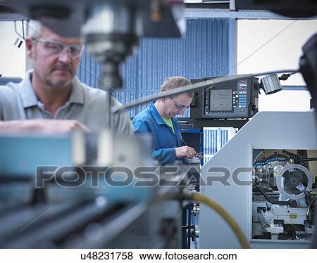 Lathe operators working in factory View Large Photo Image Stock Photo - Lathe operators working in factory. Fotosearch