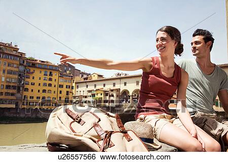 Stock Photograph - Man and woman by Ponte Vecchio, Florence, Tuscany, Italy. Fotosearch