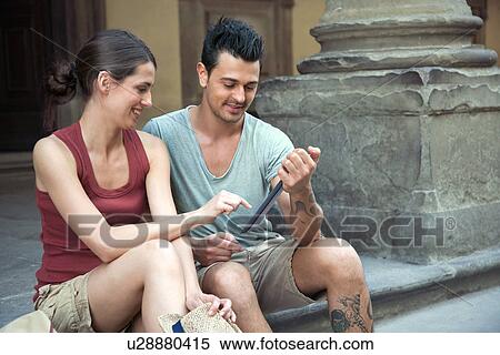 Man and woman sitting on steps of Uffizi Gallery, Florence, Tuscany, Italy View Large Photo Image Stock Photography - Man and woman sitting on steps of Uffizi Gallery, Florence, Tuscany, Italy. Fotosearch