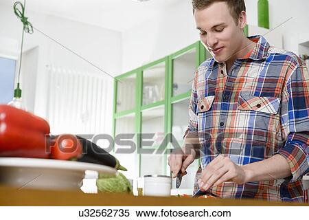 Man cutting vegetable View Large Photo Image Stock Photography - Man cutting vegetable. Fotosearch