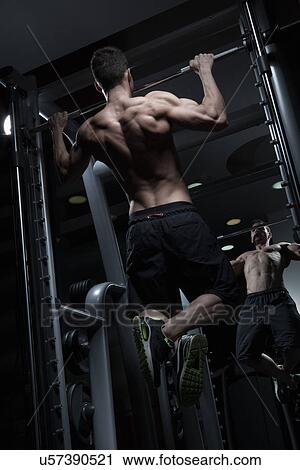 Man doing chin-ups View Large Photo Image Stock Image - Man doing chin-ups. Fotosearch