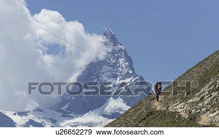 Stock Photo - Man hiking towards the Matterhorn, Zermatt, Canton Wallis, Switzerland. Fotosearch