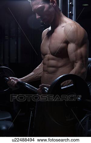 Picture - Man lifting barbell. Fotosearch
