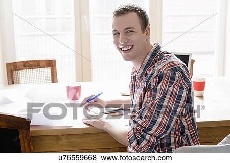 Stock Photo - Man looking up from paperwork. Fotosearch