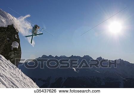 Man skiing off cliff, Verbier, Switzerland View Large Photo Image Stock Photograph - Man skiing off cliff, Verbier, Switzerland. Fotosearch