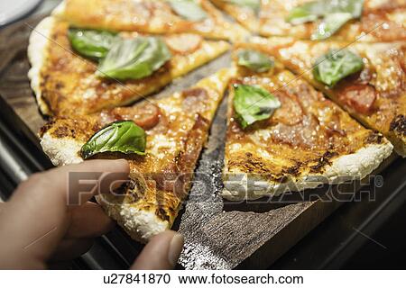 Man taking slice of pizza View Large Photo Image Stock Image - Man taking slice of pizza. Fotosearch