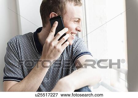 Stock Photo - Man talking on mobile phone. Fotosearch