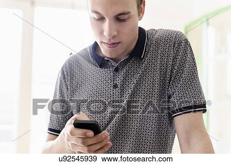 Man using mobile phone View Large Photo Image Stock Photo - Man using mobile phone. Fotosearch