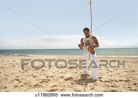 Man with berimbau on beach View Large Photo Image Stock Photography - Man with berimbau on beach. Fotosearch