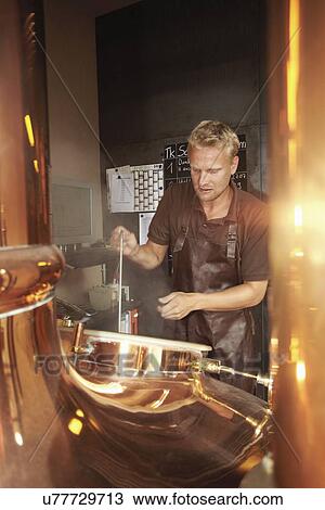 Stock Image - Man working at brewery. Fotosearch