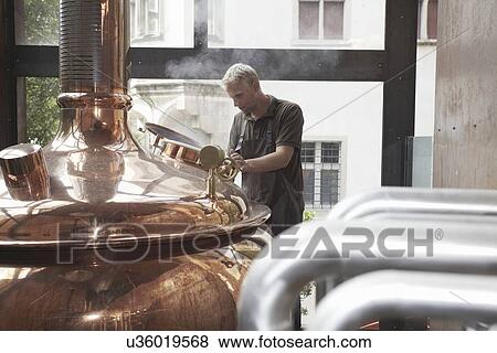 Man working at brewery View Large Photo Image Stock Photo - Man working at brewery. Fotosearch