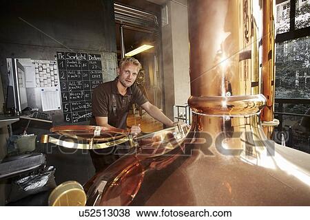Man working at brewery View Large Photo Image Stock Photo - Man working at brewery. Fotosearch