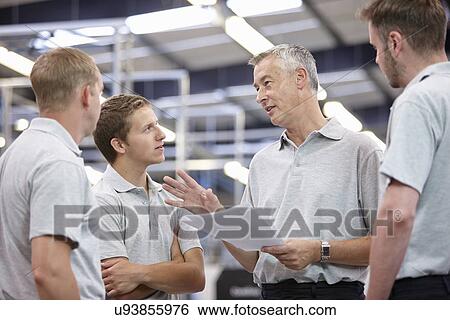 Manager and workers meeting in engineering factory View Large Photo Image Stock Photograph - Manager and workers meeting in engineering factory. Fotosearch