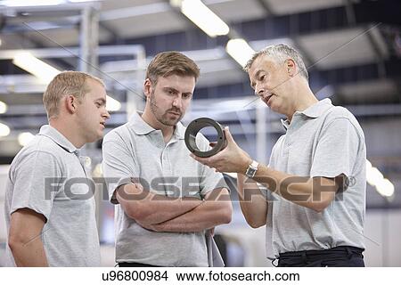 Manager discussing component in engineering factory View Large Photo Image Picture - Manager discussing component in engineering factory. Fotosearch