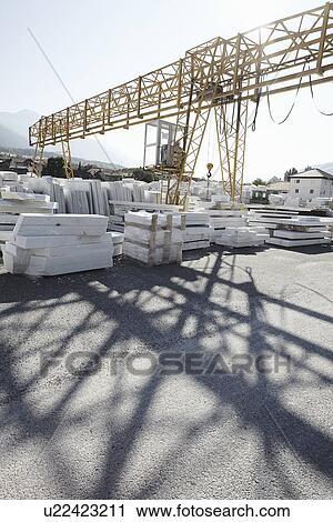Stock Image - Marble slabs stacked outside. Fotosearch