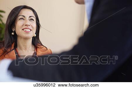 Mature businesswoman in meeting, smiling View Large Photo Image Stock Image - Mature businesswoman in meeting, smiling. Fotosearch