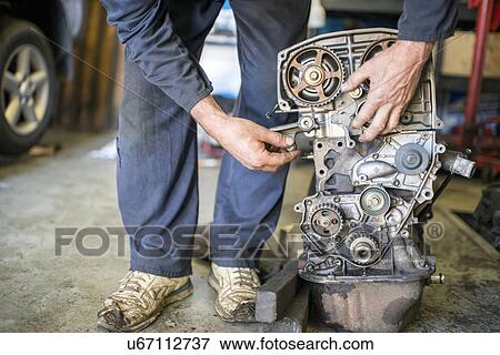 Mechanic working on car part View Large Photo Image Stock Photo - Mechanic working on car part. Fotosearch
