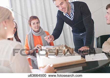 Meetings in architects office, looking at model View Large Photo Image Stock Image - Meetings in architects office, looking at model. Fotosearch