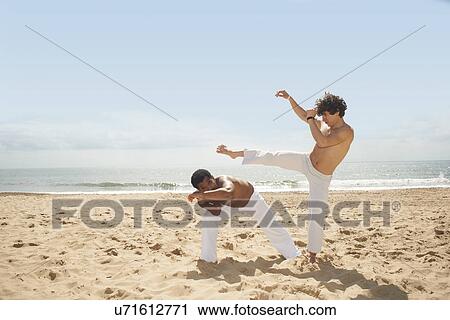 Men doing capoeira on beach View Large Photo Image Stock Image - Men doing capoeira on beach. Fotosearch