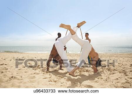 Men doing capoeira on beach View Large Photo Image Stock Image - Men doing capoeira on beach. Fotosearch