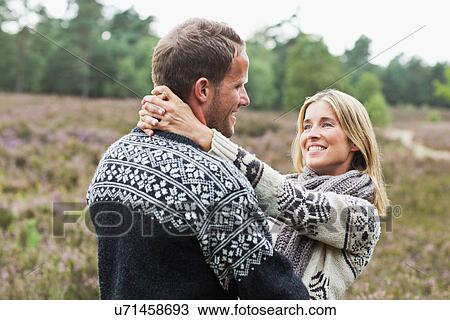 Stock Image - Mid adult couple hugging. Fotosearch