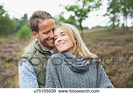 Stock Photo - Mid adult couple hugging. Fotosearch