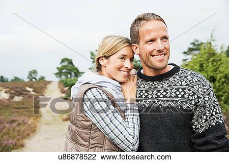 Mid adult couple looking away, smiling View Large Photo Image Stock Image - Mid adult couple looking away, smiling. Fotosearch