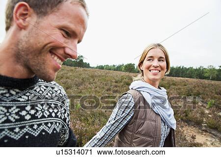 Stock Image - Mid adult couple smiling, close up. Fotosearch