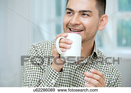 Mid adult man having coffee View Large Photo Image Stock Photo - Mid adult man having coffee. Fotosearch