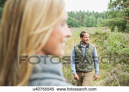 Mid adult man looking away, woman blurred in foreground View Large Photo Image Stock Photography - Mid adult man looking away, woman blurred in foreground. Fotosearch