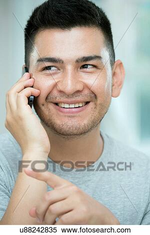 Mid adult man on telephone call, pointing View Large Photo Image Stock Photography - Mid adult man on telephone call, pointing. Fotosearch
