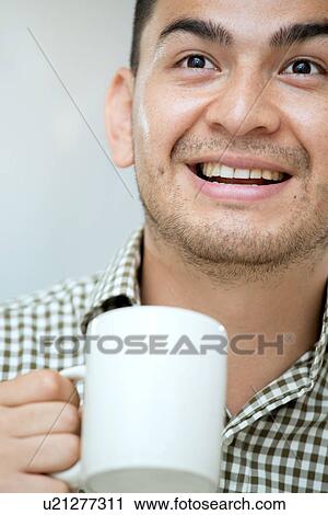 Stock Image - Mid adult man with a coffee. Fotosearch