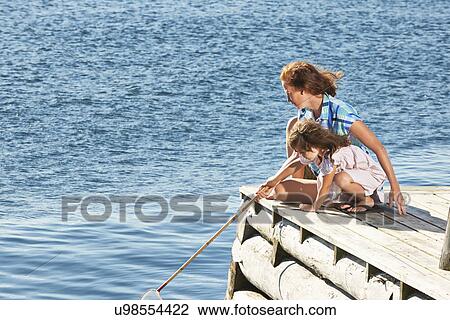 Mother and daughter with fishing net, Utvalnas, Gavle, Sweden View Large Photo Image Stock Image - Mother and daughter with fishing net, Utvalnas, Gavle, Sweden. Fotosearch