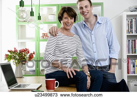 Stock Image - Mother and son looking at camera. Fotosearch